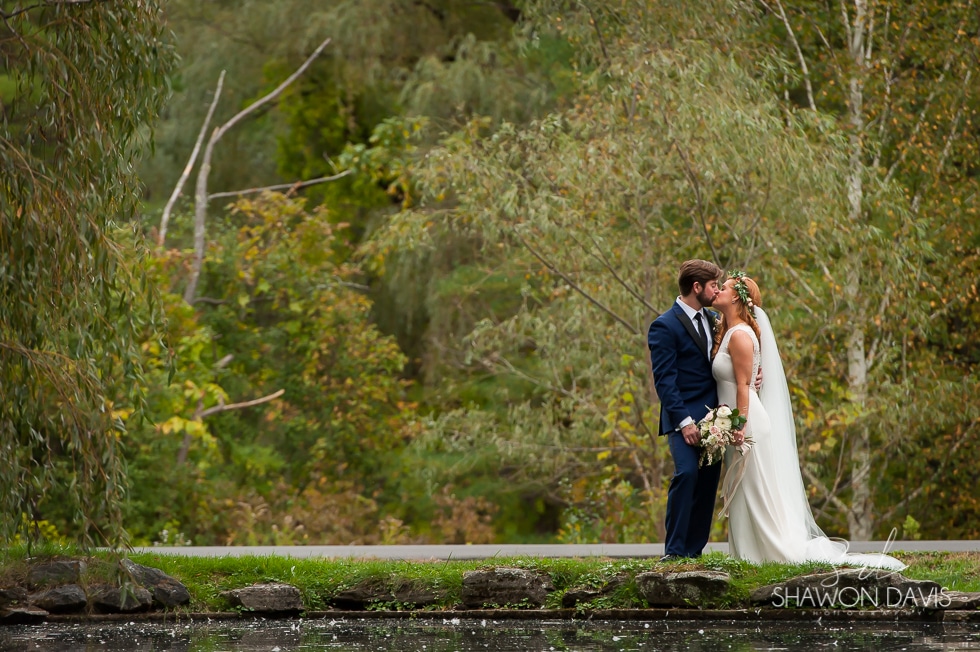 Stonover Farm wedding photo of bride and groom kissing near the pond