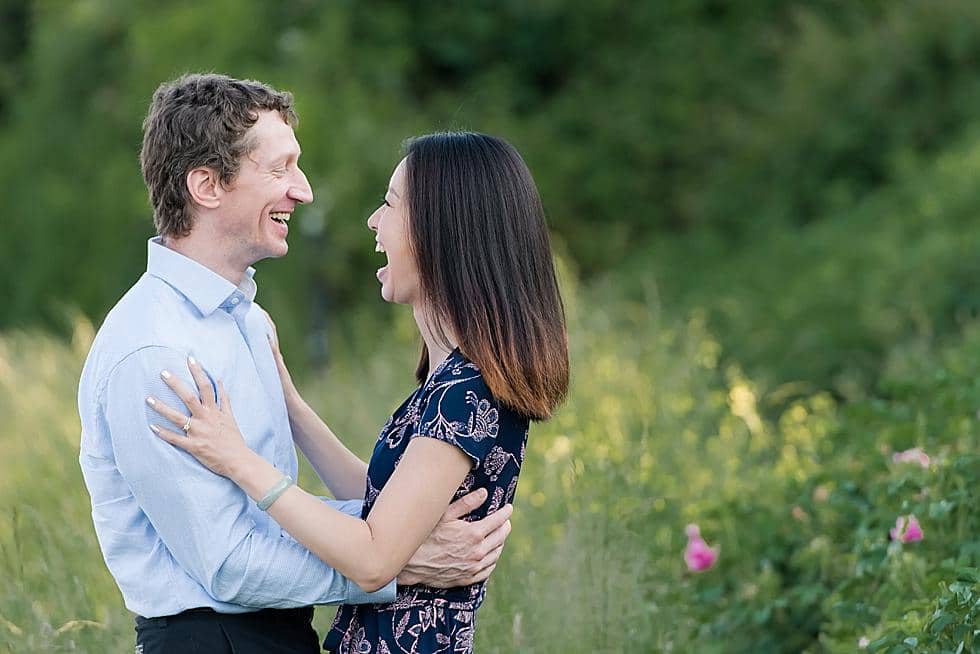 Couple laughing at Newport Cliff Walk engagement session photo