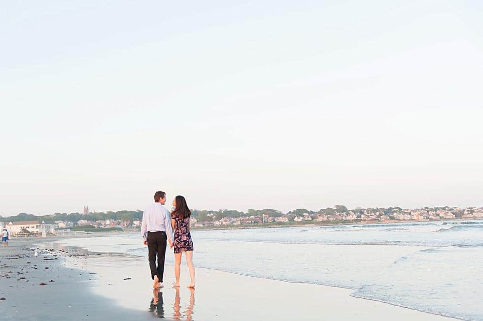 Couple walking on Easton's beach engagement session photo