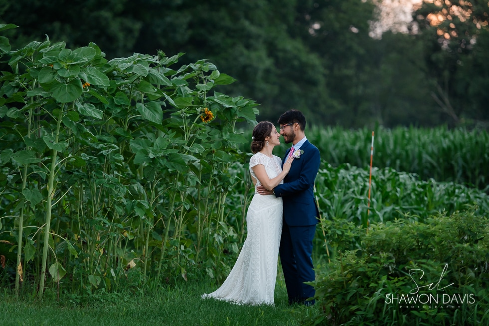 friendly crossways bride and groom with sunflowers wedding photo