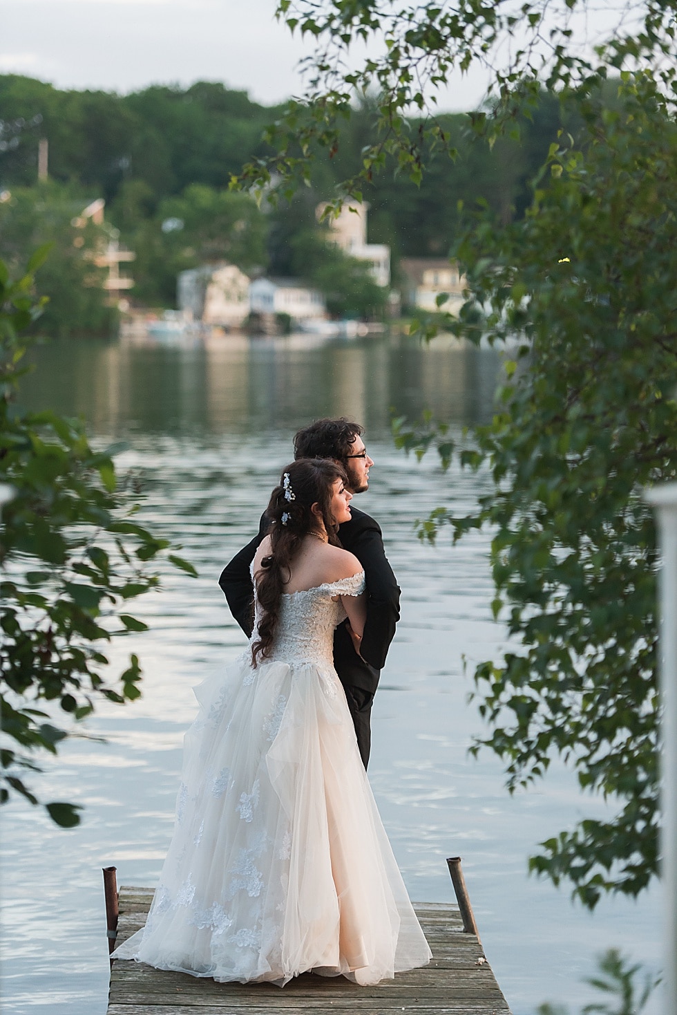 bride and groom on the dock at Lake Pearl